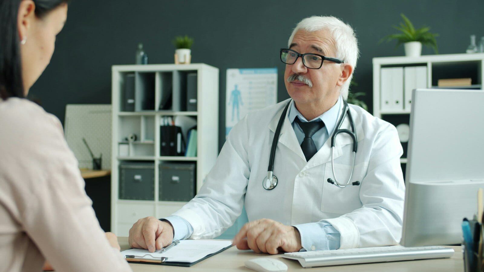 Doctor consults with patient in modern office